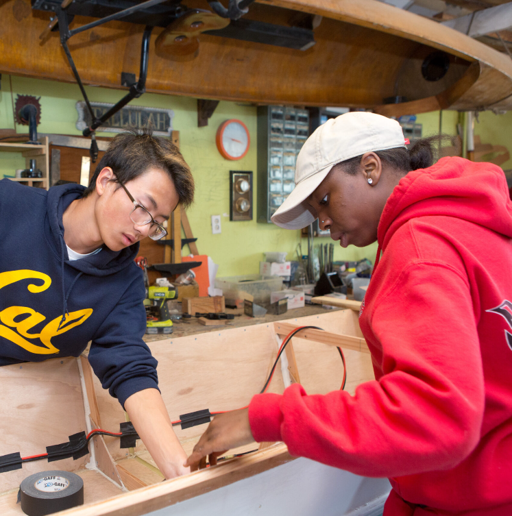 Students working together in a tech-ed class, embodying New Village Academy’s Core Values of innovation and collaboration.